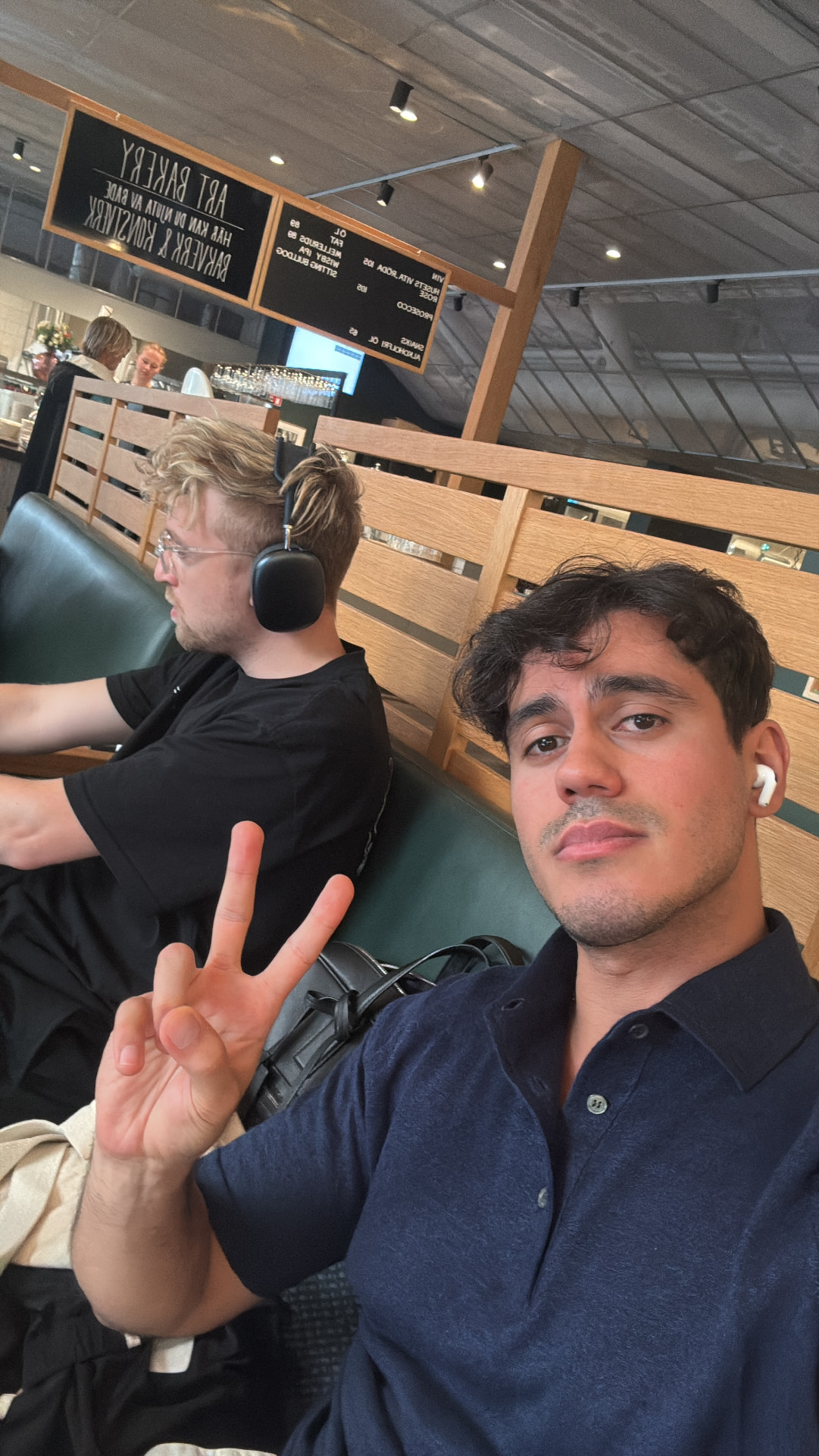 Me in a Stockholm bakery, throwing a peace sign